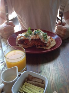 EL MONTANERO “SUPERBEASTO”: 2 fried eggs, chorizo con papas, pork charro beans, chicharron, fried plantain, burro rice, chipotle mayo, baja cream, crispy tortilla 